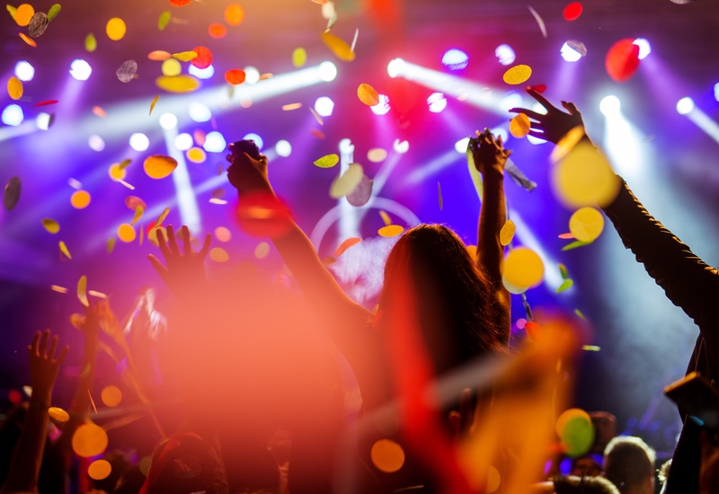 people dancing with confetti cannons